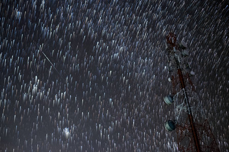 star trails with meteor shower with long exposure in the night sky can be used as background