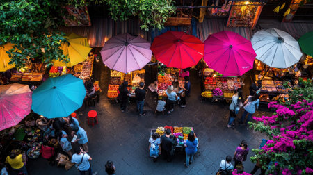 A vibrant market scene showcasing colorful umbrellas and fresh produce, bustling with shoppers and vendors during an enchanting evening atmosphere.の素材