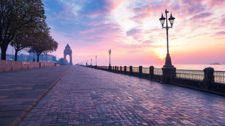 A tranquil promenade at sunset showcases colorful skies and lantern lights along the pathway, creating a peaceful atmosphere by the coastline.の素材