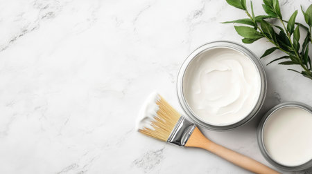 A serene arrangement featuring creamy moisturizer in jars with a brush and fresh green leaves on a marble surface, perfect for wellness and beauty themes.の素材