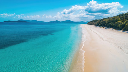 A stunning aerial view of a tranquil beach showcasing clear turquoise water, soft sand, and a picturesque sky. Ideal for relaxation and vacation themes.の素材