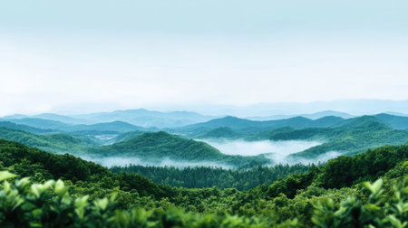 A breathtaking view of lush green mountains surrounded by mist, showcasing the tranquility of nature. Perfect for travel and outdoor enthusiasts.の素材