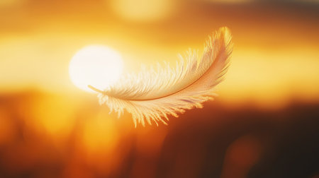 A delicate feather suspended in the air at sunset. The warm, golden hues create a serene and tranquil atmosphere, symbolizing freedom and elegance.の素材