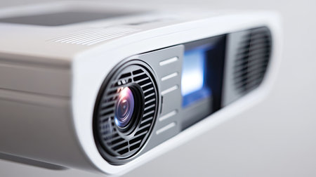 This image showcases a modern projector with a clear lens and sleek design. Ideal for presentations, classrooms, and home theaters, this device highlights innovative technology and functionality.の素材