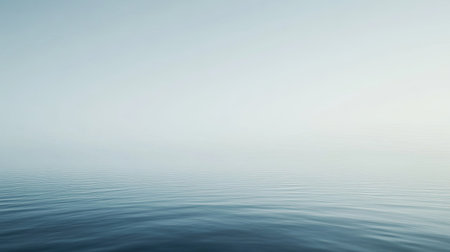 A serene water surface reflects soft light and gentle ripples, creating a minimalist and tranquil atmosphere. Ideal for relaxation and calmness.の素材