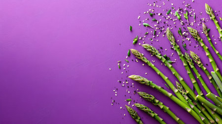 Fresh green asparagus arranged artfully on a vibrant purple background, perfect for culinary projects. Ideal for healthy meal inspirations and food photography.の素材