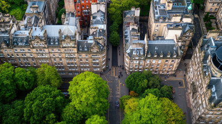 Captured from above, this image showcases a vibrant urban landscape featuring historic architecture intertwined with lush greenery, illustrating the balance between nature and city life.の素材