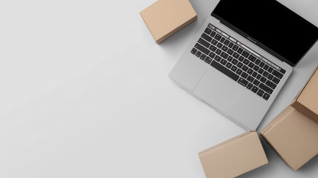 Laptop and shipping boxes on a clean background, with space for text.の素材