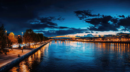 A breathtaking view of a river at dusk, showcasing vibrant colors in the sky and shimmering reflections of city lights on the water. Perfect for travel and urban scenery.の素材