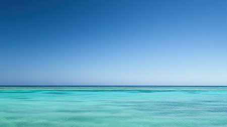 Calm tropical ocean with a clear blue sky, leaving space for copy on the horizonの素材