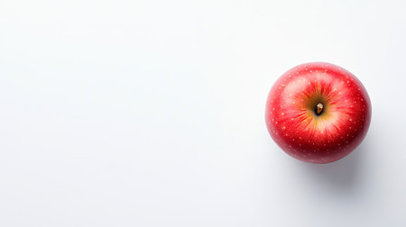 Top view of a fresh red apple placed on a clean white background, with ample copy space for text or designの素材
