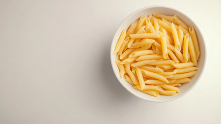 Top view of a bowl of penne pasta, simple and minimalist, with open white space for copyの素材