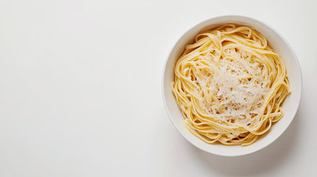 Top view of a bowl of linguine with parmesan cheese on a white background, leaving space for copyの素材