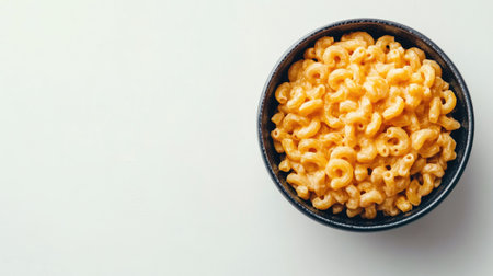 Top view of a bowl of macaroni and cheese on a white background, with copy space availableの素材