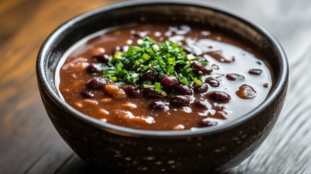 A bowl of Korean red bean soup (patjuk) with sweet red beans. Great for traditional dessert contentの素材