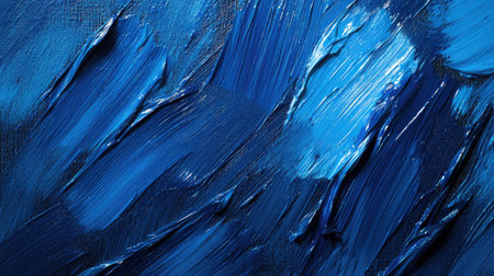 A top-down view of blue paintbrush strokes across a canvas, showcasing a range of blue hues and brush texturesの素材