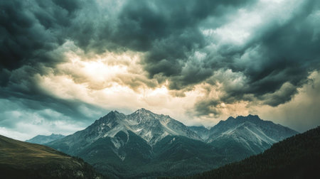 Dramatic storm clouds over a mountain range, with plenty of room for text.の素材