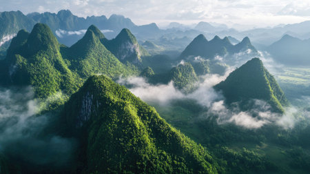 Stunning Southeast Asian mountain range with mist-covered peaks, lush valleys belowの素材