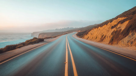 A quiet coastal road in California with the ocean on one side and cliffs on the other. No people, copy space.の素材