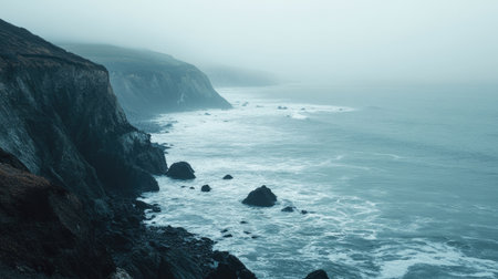 A serene view of the Pacific coastline with cliffs and crashing waves. No people, copy space.の素材