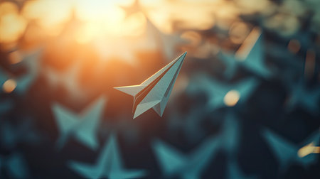 Unique paper plane rising into the sunlight, with other planes falling into shadows, creating a striking visual contrastの素材