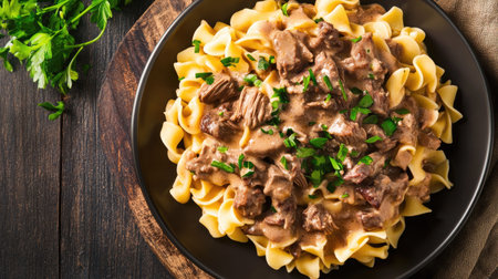 Overhead view of a hearty and flavorful beef stroganoff with noodlesの素材