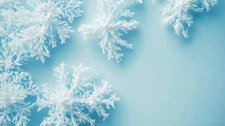Beautiful frosty snowflakes scattered on a serene blue background, creating a tranquil winter scene. Perfect for seasonal designs, themes, and decorations.の素材