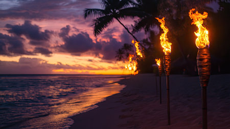 Experience a breathtaking tropical beach scene at sunset, featuring flaming tiki torches and silhouette palm trees along a serene shoreline.の素材
