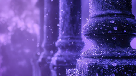 Captivating raindrops cling to ornate stone pillars, set against a dreamy purple background. The soft focus creates an enchanting atmosphere perfect for artistic projects.の素材