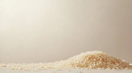 A closeup view of a mound of white rice on a soft light background, showcasing the fine texture and natural beauty of this essential culinary ingredient. Perfect for food-related projects.の素材