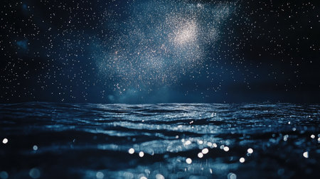 This stunning image features a starry night sky hovering above tranquil ocean waves, with shimmering water reflections creating a serene environment.の素材