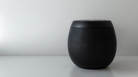 This image shows a modern wireless speaker on a minimalist surface, perfect for contemporary home decor. The product highlights modern design and functionality.の素材