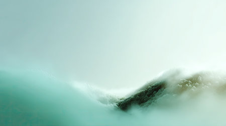 A tranquil coastal scene showcases misty ocean waves gently rolling against a serene green landscape, creating a peaceful and idyllic atmosphere.の素材