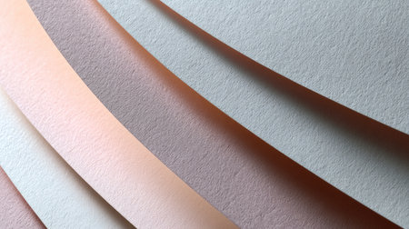 Close-up view of soft pastel paper sheets arranged in flowing curves, showcasing subtle textures and colors suitable for creative projects and designs.の素材