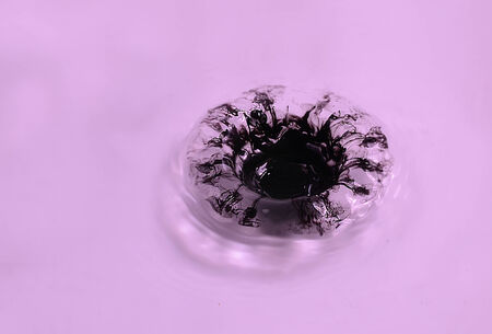 water splash on dark purple ground.の写真素材