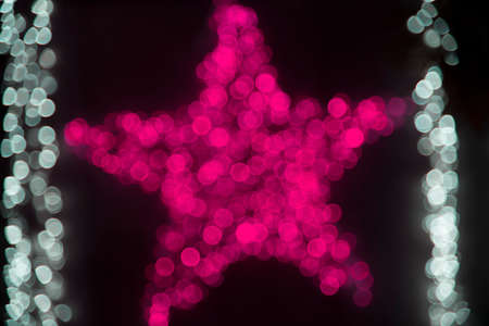 Decorations on the Christmas lights and the general pattern in sparkling blurred backgroundの写真素材