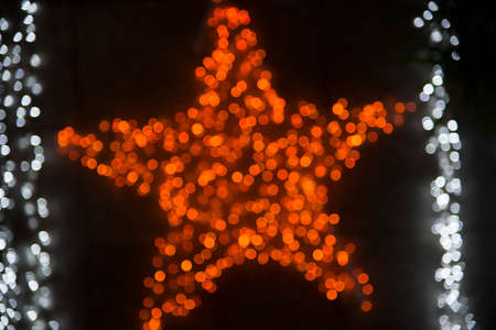 Decorations on the Christmas lights and the general pattern in sparkling blurred backgroundの写真素材