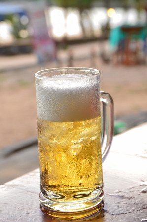 Glass of beer on the restaurant tableの写真素材