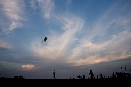 Kite flying in the blue sky at the festival.の写真素材