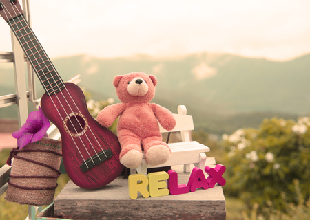 Toy bears sitting on a chair in the background scenery blurred.の写真素材