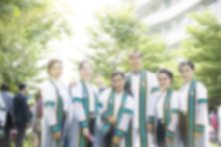 Graduation dress was photographed together with relatives at the universityの写真素材