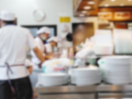 Restaurant interior with chefs and customers blurred backgroundの写真素材