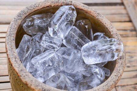  Ice cubes on wooden bucket on Texture backgroundの写真素材