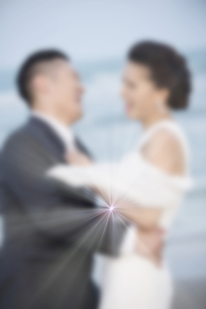 < mixed Blur the married couple walking on the beach happy and romantic love scene.の写真素材