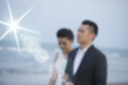 < mixed Blur the married couple walking on the beach happy and romantic love scene.の写真素材