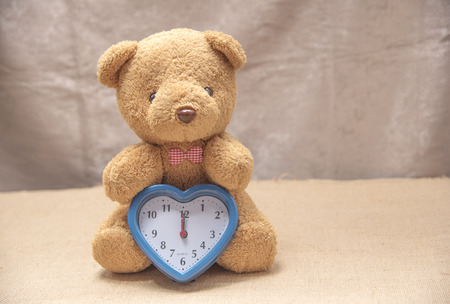 Teddy Bear with Brown Time, Brown Background Sceneの写真素材