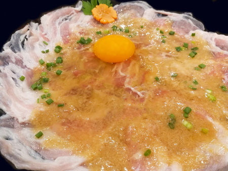 Pork sliced sliced with eggs On the black backgroundの写真素材