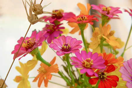 Fake flowers bouquet on the background of the wallpaper concept.の写真素材