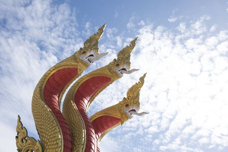 serpent three head on blue sky at WAT MUANG thailand, the concept is the wallpaper background.