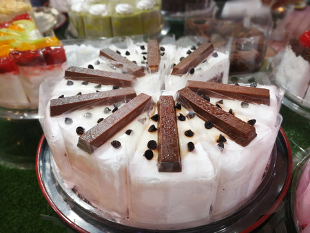 orange butter cake topping peanut and dried fruit salad on plateの写真素材